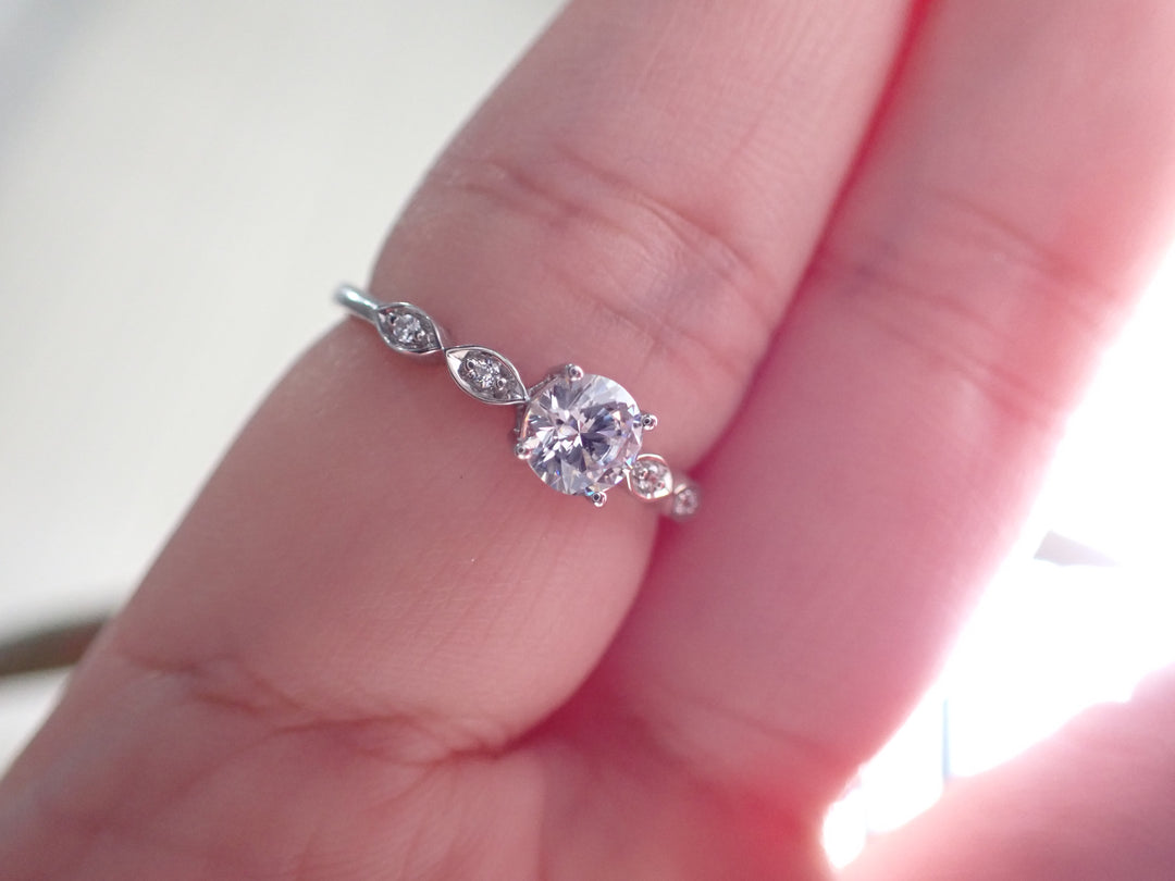 Engagement Ring with a Center Round White Diamond and Round White Diamond Side Stones | Fête Matrimony XXV