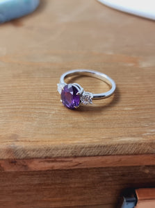 Platinum Ring with 15 Pointer Diamonds on the Side and Oval Purple Sapphire in the Center